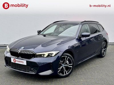 Blauw (metallic) Occasion 2023 BMW 320e Executive Stationwagen | € 36.895 (Eerlijke prijs)