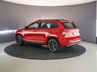 tweedehands Skoda Karoq Sportline Business 1.5 TSI 150pk DSG Automaat Panoramadak, Elektrische achterklep, Navigatie, Achteruitrijcamera, Cruise control, Airco, Parkeersensoren, Verwarmde voorruit, Stoelverwarming