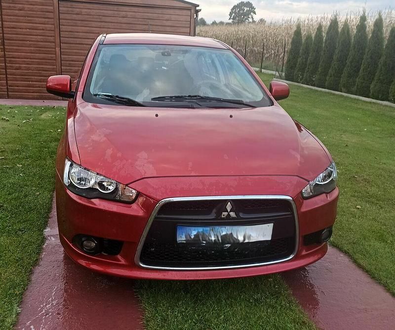 Czerwony Używany 2011 Mitsubishi Lancer Hatchback | 20 000 zł (Uczciwa cena) - Obraz 1/4