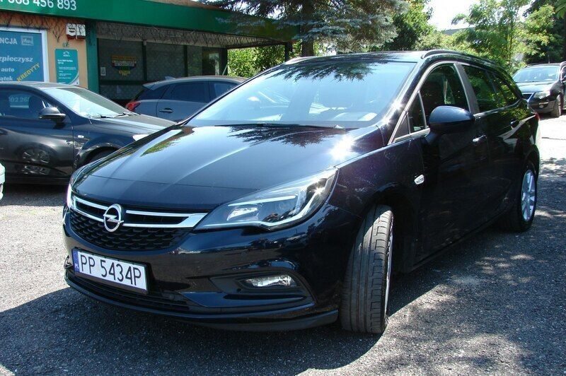 Grafitowy (metalik, perła) Używany 2018 Opel Astra Sedan/Limuzyna | 34 900 zł (Uczciwa cena) - Obraz 1/4