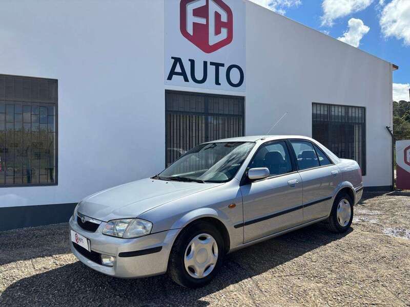 Cinzento Usado 2000 Mazda 323 | € 2.900 - Imagem 1/4