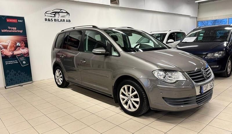 Grå Begagnad 2010 VW Touran Freestyle Minibuss | 79 900 kr (Marknadspris) - Bild 1/4