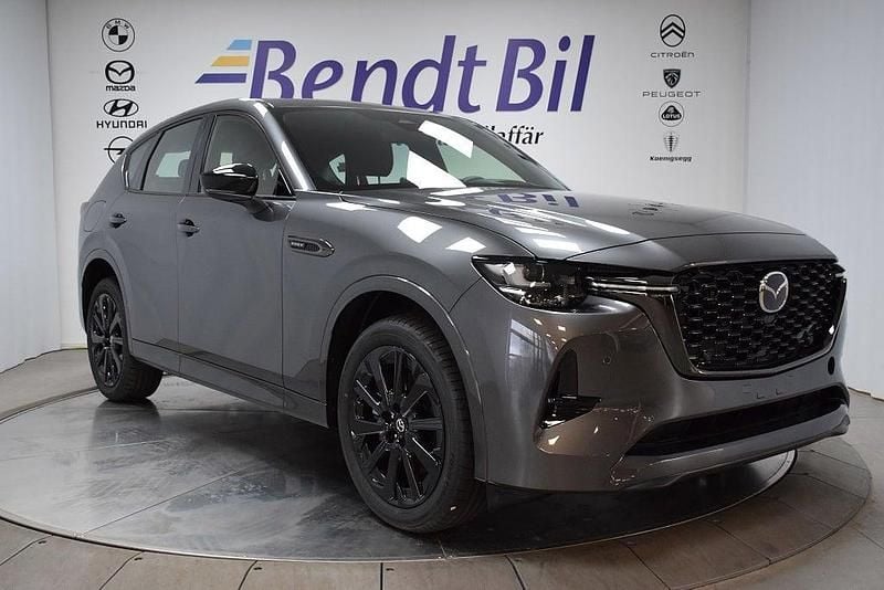 Grå Begagnad 2025 Mazda CX-60 Homura-Line SUV | 559 500 kr (Marknadspris) - Bild 1/2