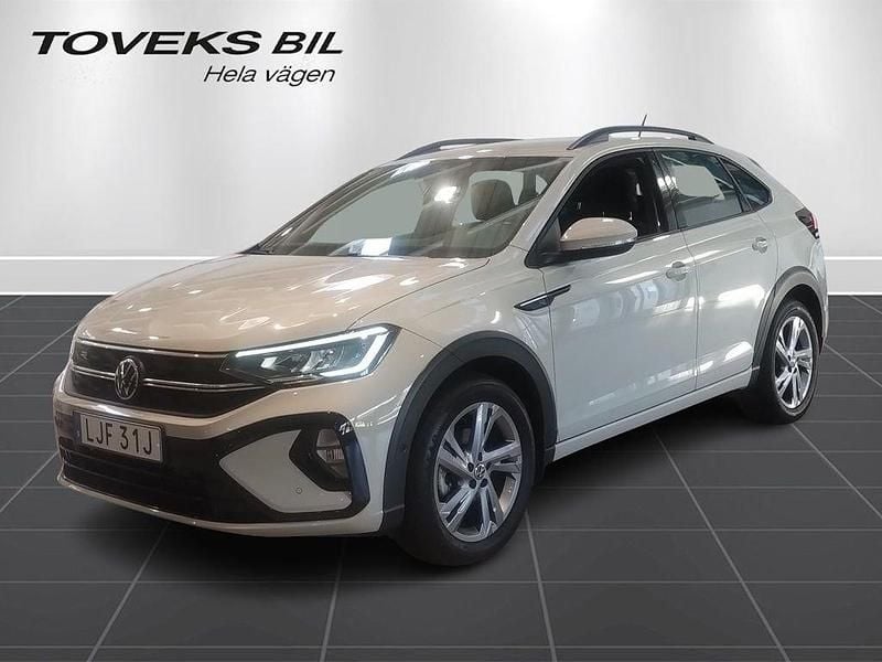 Grå (ascot grey) Begagnad 2022 VW Taigo R-line SUV | 229 000 kr (Marknadspris) - Bild 1/4