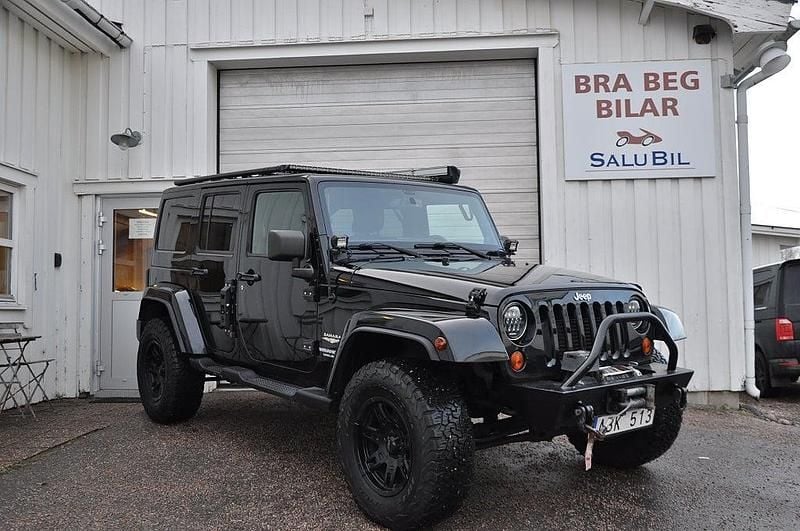 Svart Begagnad 2012 Jeep Wrangler Unlimited Sahara SUV | 299 000 kr - Bild 1/4