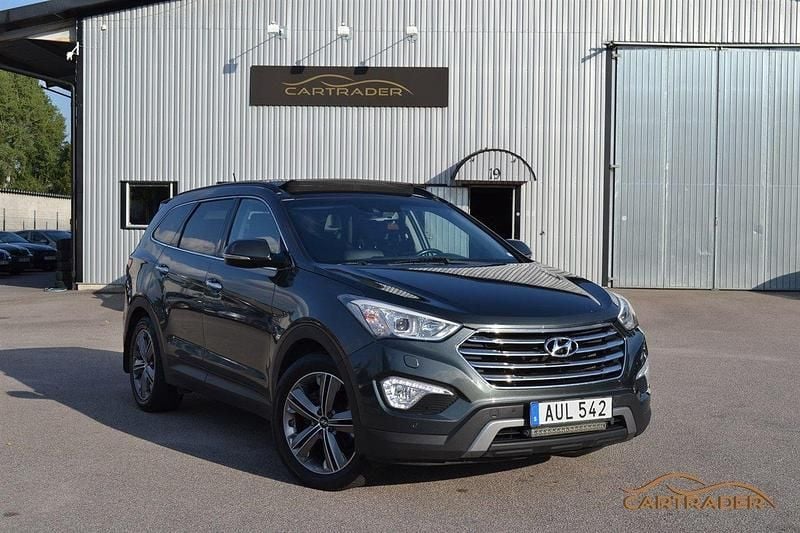 Mörkgrön (grön) Begagnad 2014 Hyundai Grand Santa Fe Premium SUV | 149 900 kr (Lite dyr) - Bild 1/4