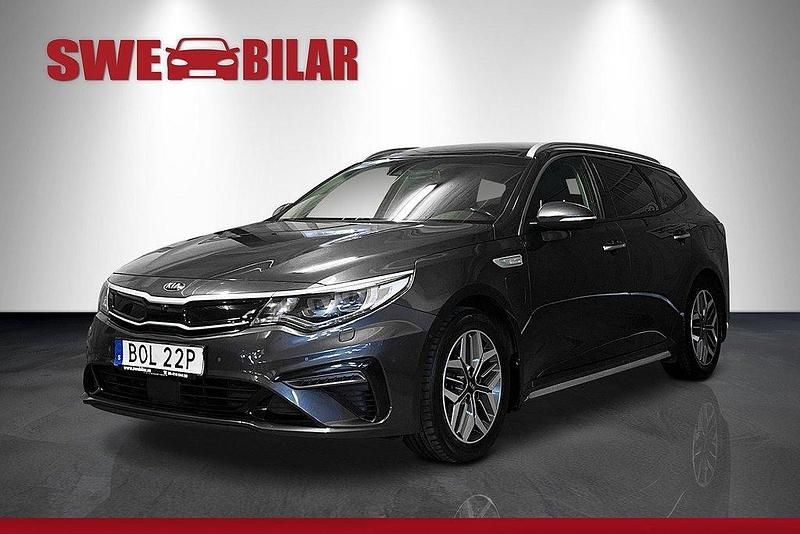 Grå Begagnad 2019 Kia Optima Hybrid Plus Sedan | 234 900 kr (Marknadspris) - Bild 1/4