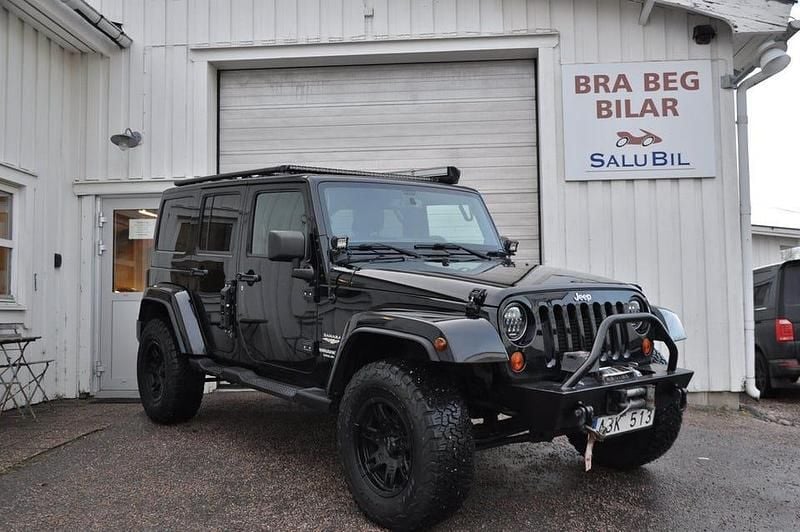 Svart Begagnad 2012 Jeep Wrangler Unlimited Sahara SUV | 299 000 kr - Bild 1/4