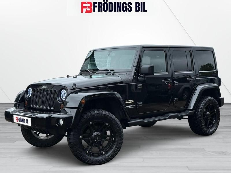 Svart Begagnad 2013 Jeep Wrangler Unlimited Sahara SUV | 309 900 kr (Marknadspris) - Bild 1/4