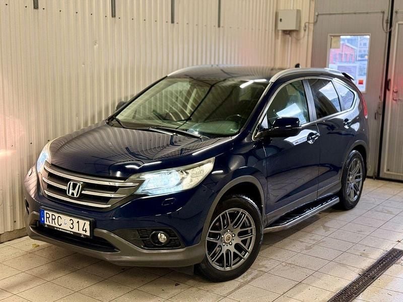 Mörkblå (blå) Begagnad 2013 Honda CR-V SUV | 135 000 kr (Marknadspris) - Bild 1/4