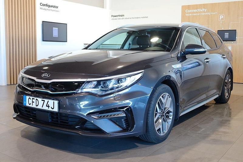 Grå Begagnad 2019 Kia Optima Hybrid Advance Sedan | 189 800 kr (Marknadspris) - Bild 1/3