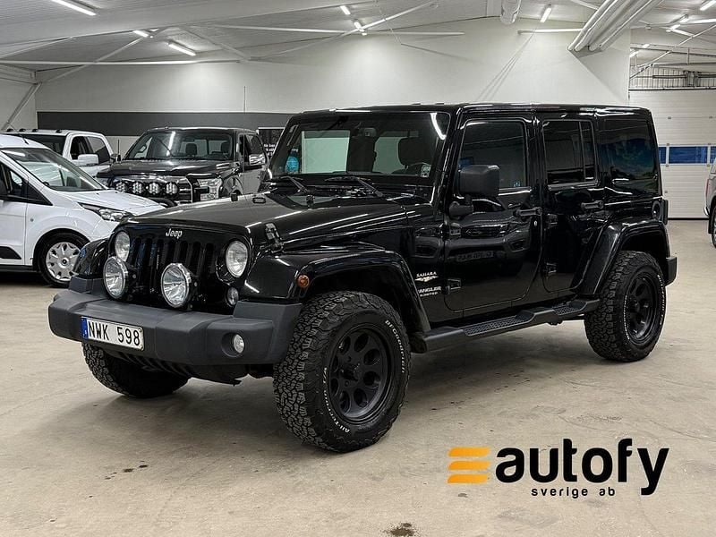 Svart Begagnad 2013 Jeep Wrangler Unlimited Sahara SUV | 269 900 kr (Bra pris) - Bild 1/4