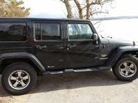 Begagnad Jeep Wrangler Unlimited 200 HK (147 kW) 2012 Svart med lite grönt skimmer SUV